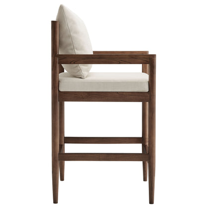 White wood counter stool with light beige cushioned seat, tapered legs and clean mid-century lines.