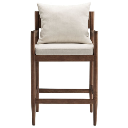 White wood counter stool with cream cushioned seat and back, armrests and footrest.