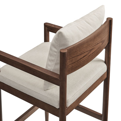 Mid-century wooden bar stool in dark walnut finish with cream fabric cushions.