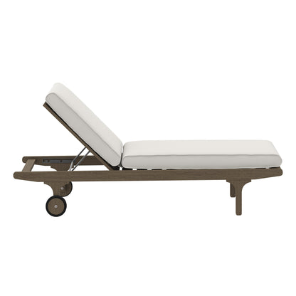 Teak outdoor chaise lounge chair with white cushions, adjustable backrest and rolling wheels for easy repositioning.