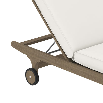 Wooden outdoor chaise with white cushions, mid-brown frame and small black wheel accents.
