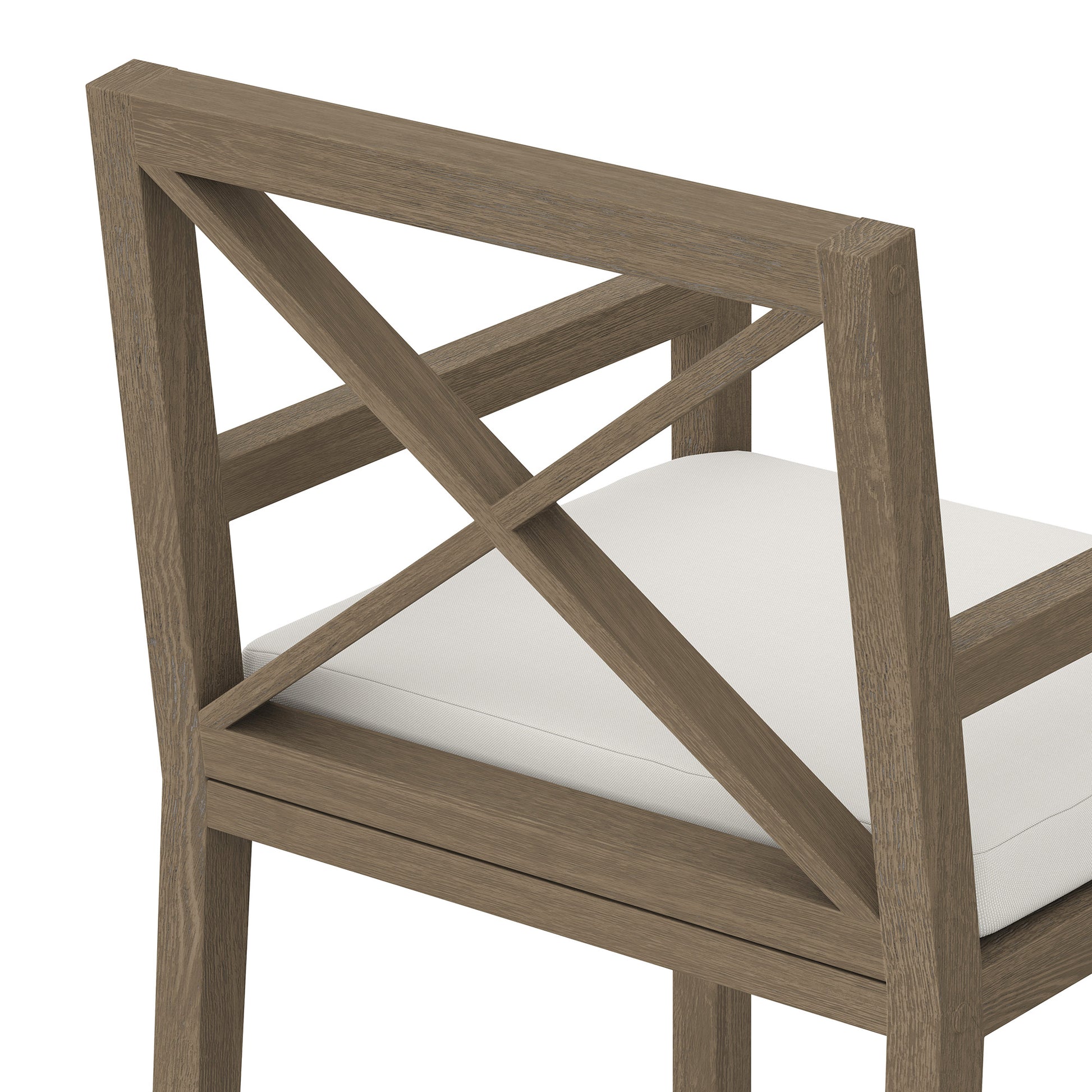 Teak outdoor dining armchair with an X-back design and a white seat cushion.
