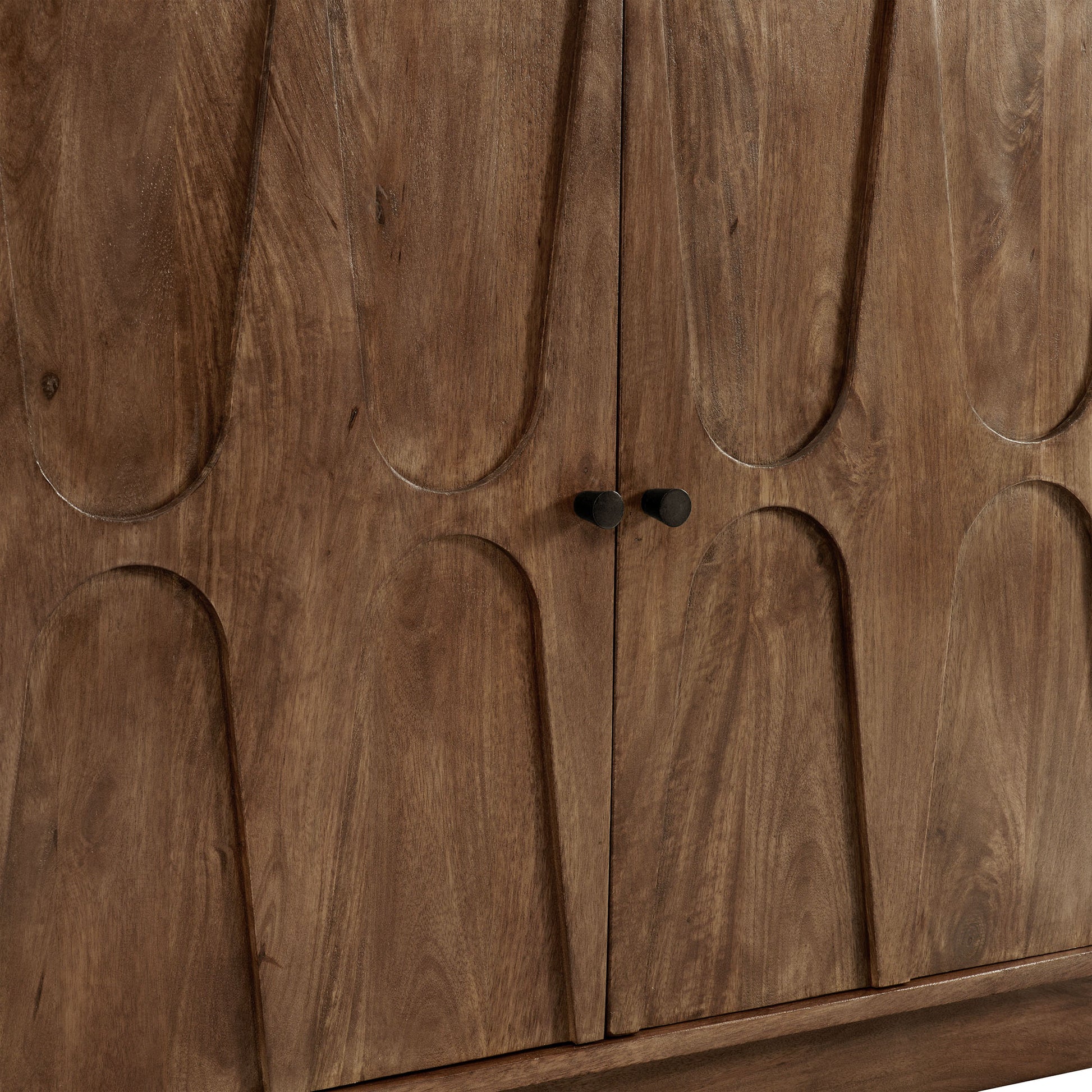 Mango wood sideboard cabinet with arched-panel doors, small dark knobs, brown wood grain.