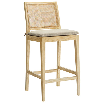 Natural oak counter stool with caned back, beige cushion, square legs, and footrest; modern rustic counter seating.