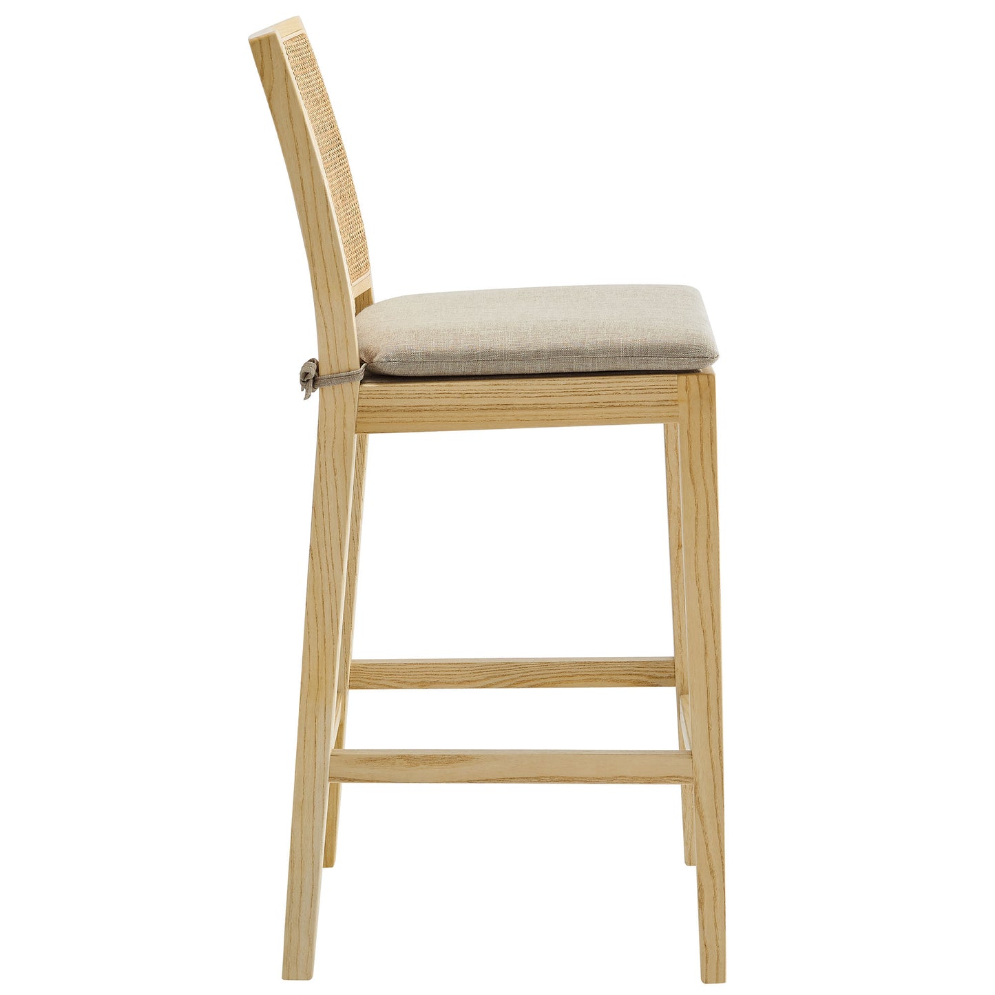 Natural wood counter stool with beige cushioned seat and woven cane back, slim frame with footrest.