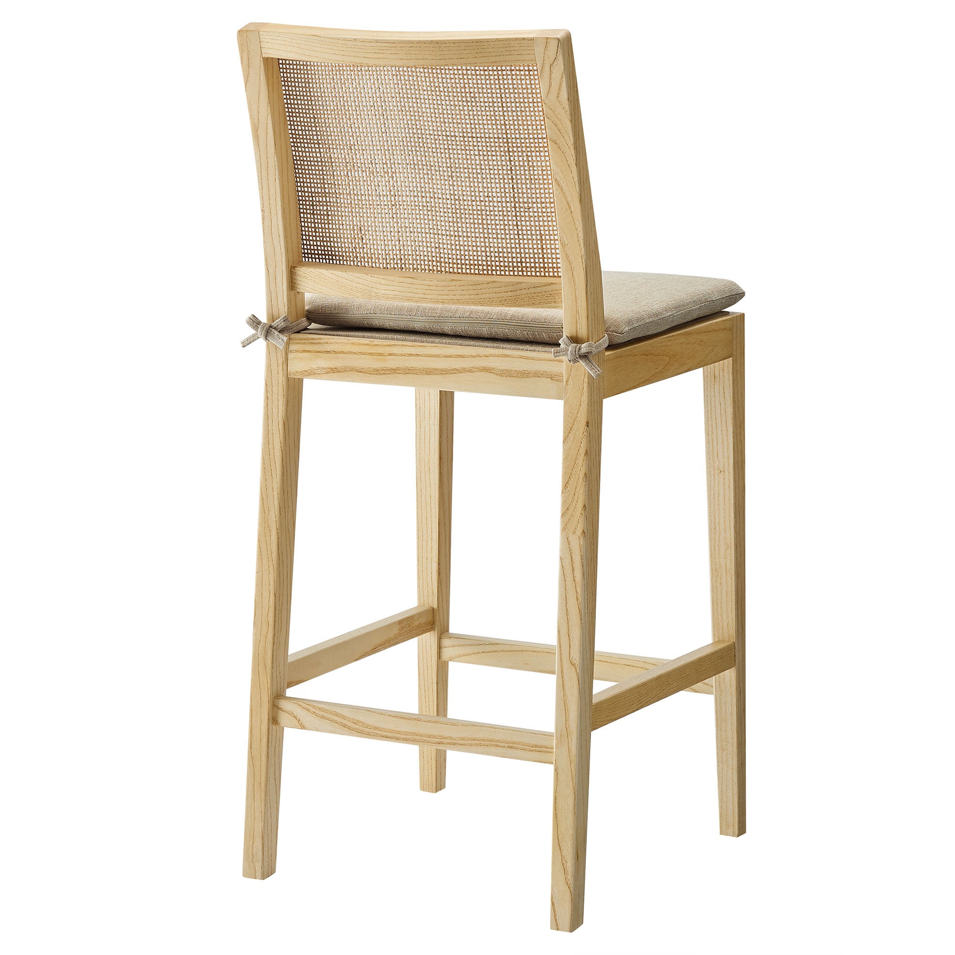 Natural wood counter stool with a cane back, beige cushioned seat, square legs and footrest