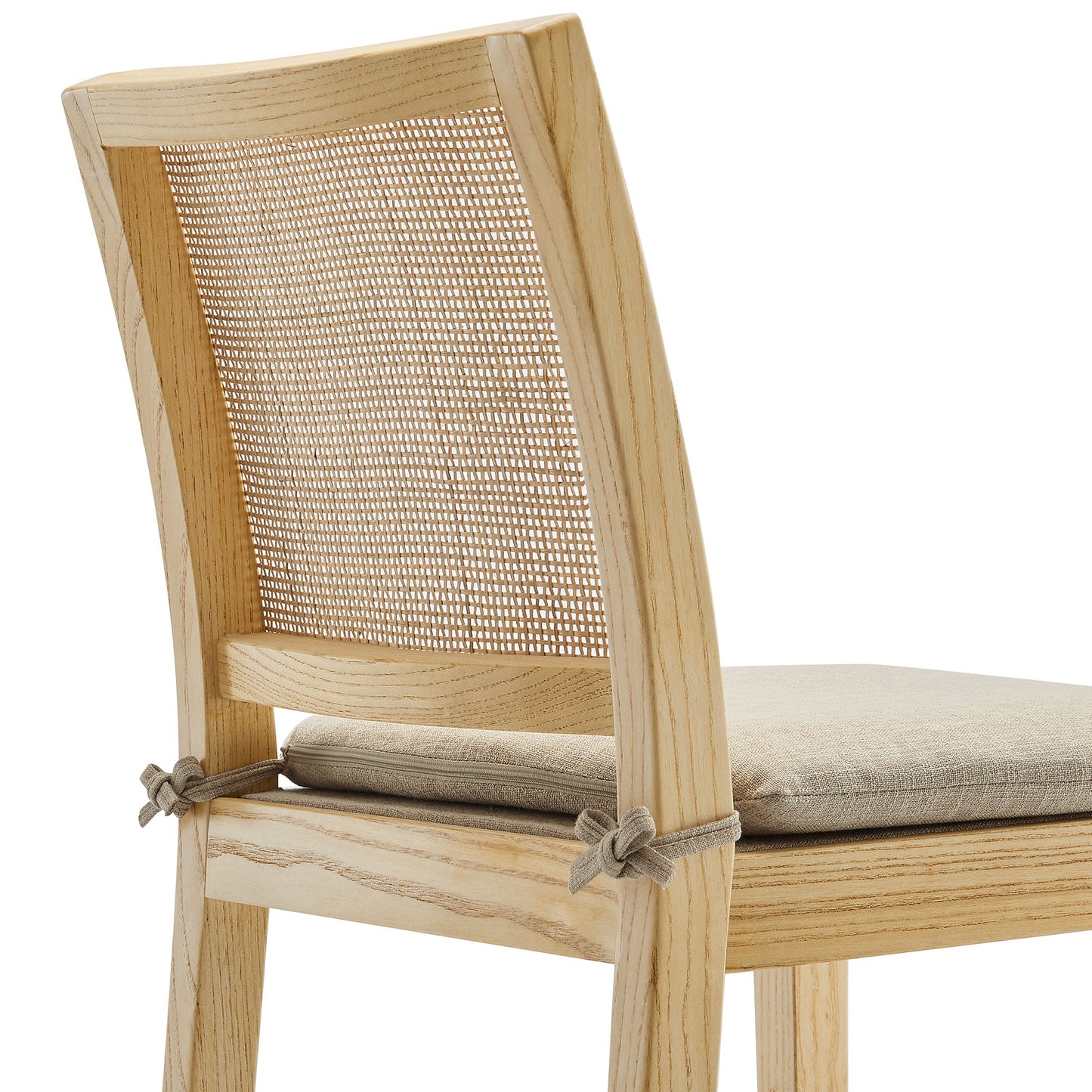 Natural wood and rattan counter stool with a caned back and beige upholstered seat cushion.