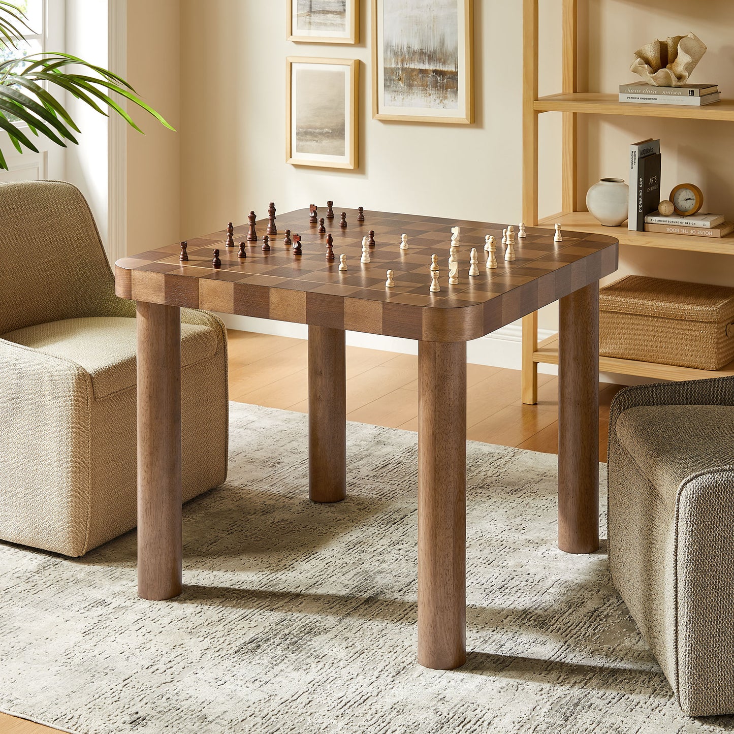Solid wood square dining table with thick legs and a checkered top, in a warm beige living room.