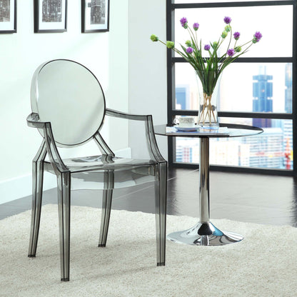 Clear acrylic dining armchairs (set of 2) with rounded backs, beside a glass-topped chrome side table and a vase of purple flowers.