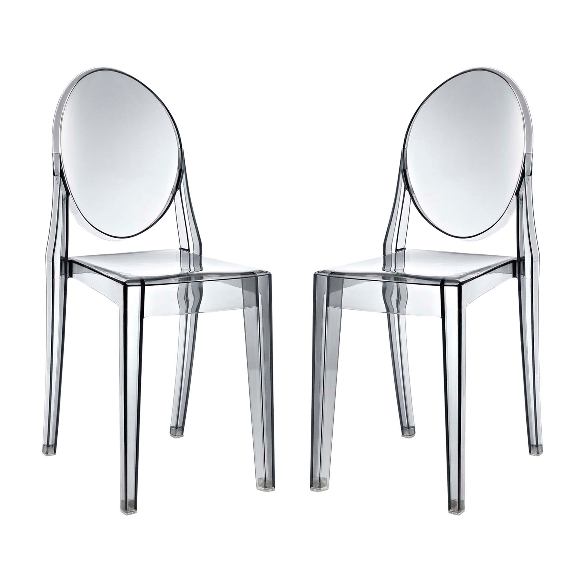 Two transparent acrylic chairs with oval backs and square seats; modern clear dining seating.