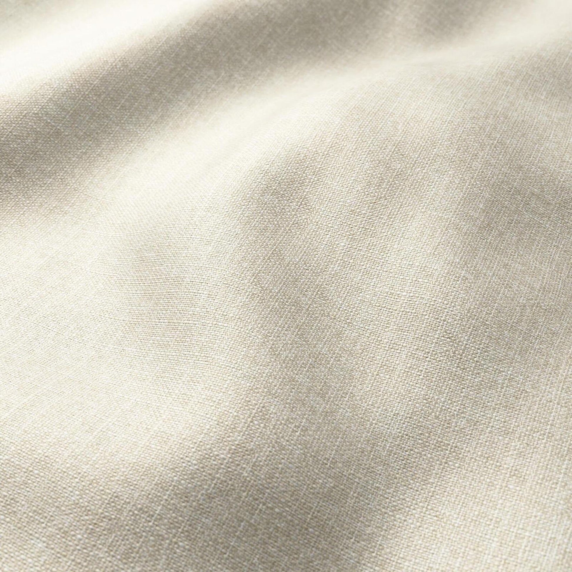 Cream-beige linen-like fabric close-up with visible weave and soft draped folds