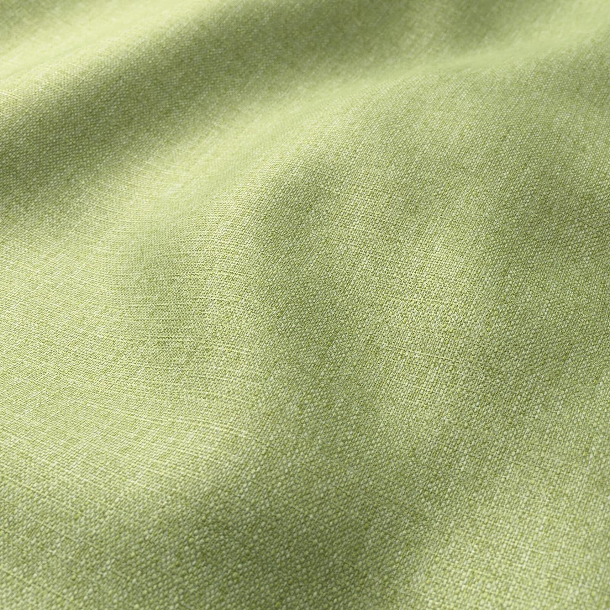 Lime-green linen-like fabric close-up with soft drape and textured weave.