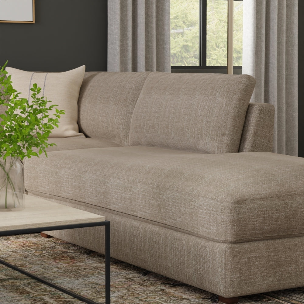 Mushroom solid fabric sectional sofa with chaise in a modern living room setting, featuring a wood-top coffee table and a green plant.