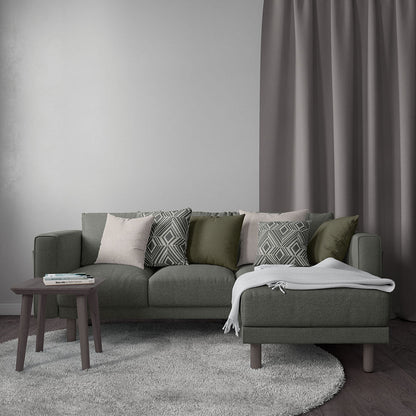 Olive green fabric sectional sofa with chaise, textured cushions, dark wood coffee table, light gray rug, contemporary style.