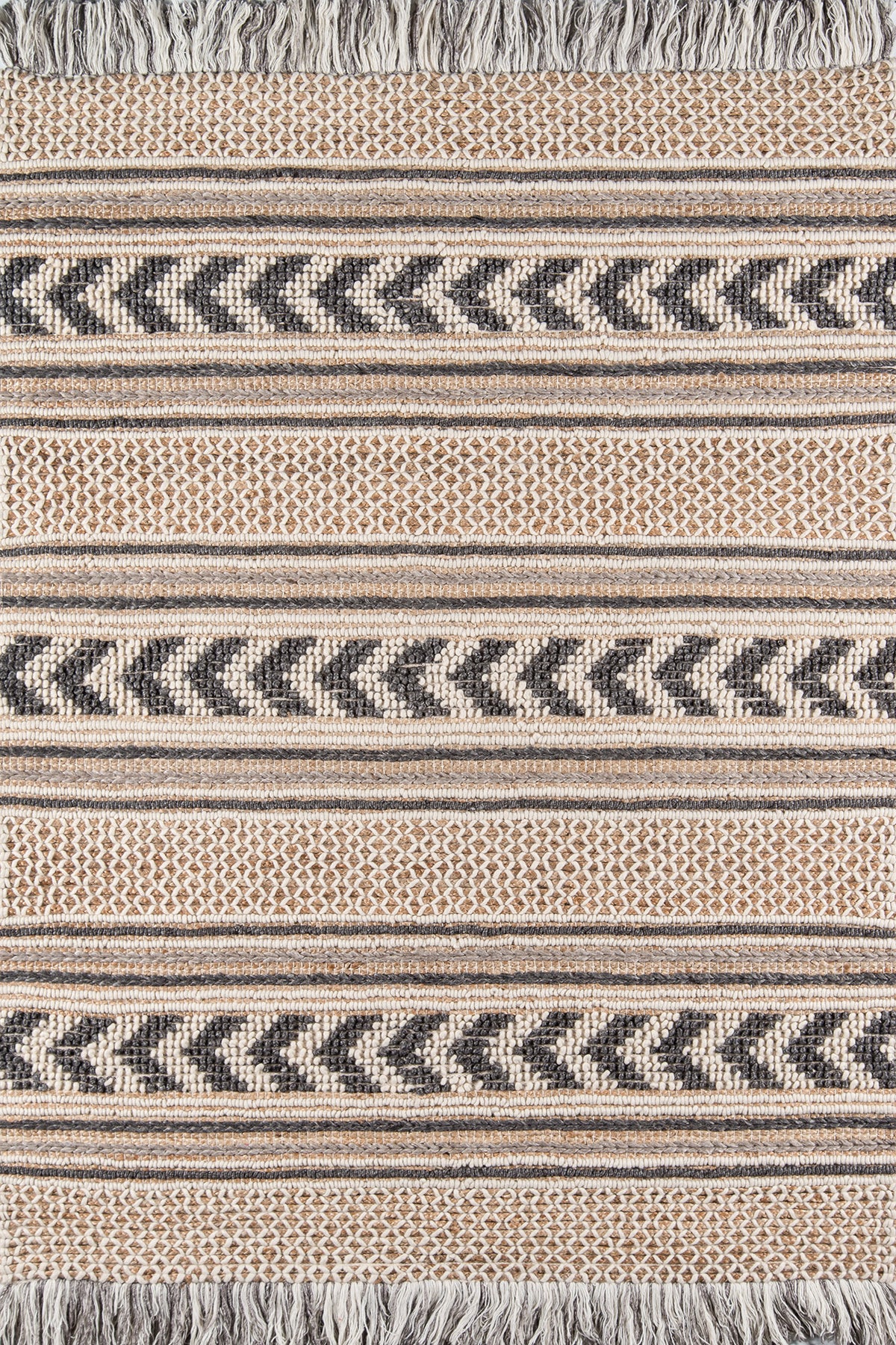 Beige and navy woven blanket with chevron zigzag stripes, subtle dot textures, fringed edges.