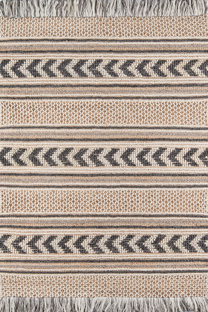 Woven striped textile rug with chevron zigzag bands in beige, tan and dark gray, fringe along the edges.