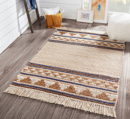 Beige woven rug with blue and brown geometric stripes and fringe, laid on a dark wood floor.