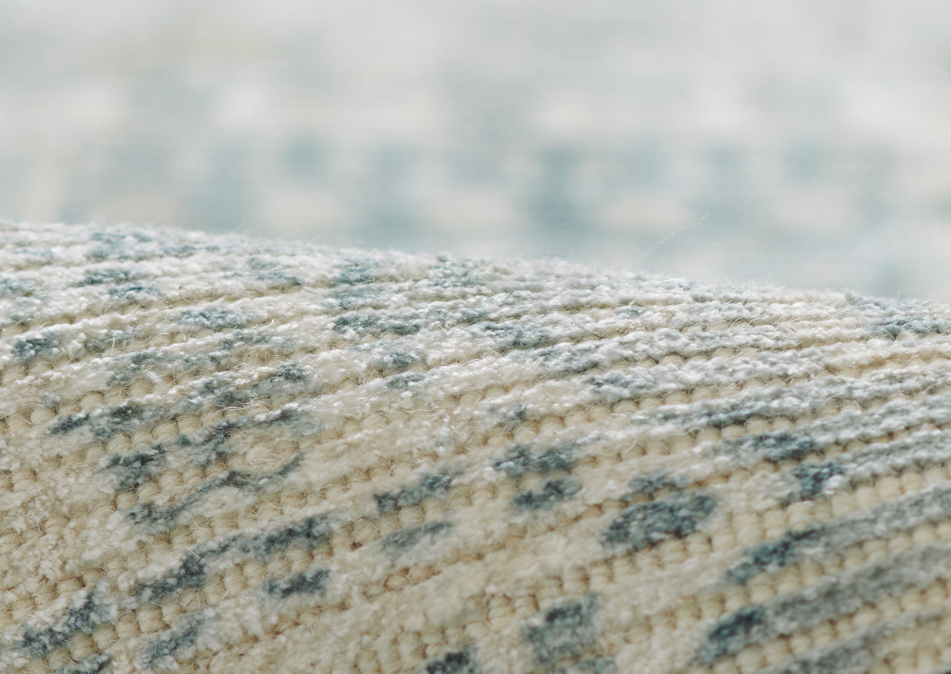 Close-up of beige woven runner with blue flecking and soft plush pile.