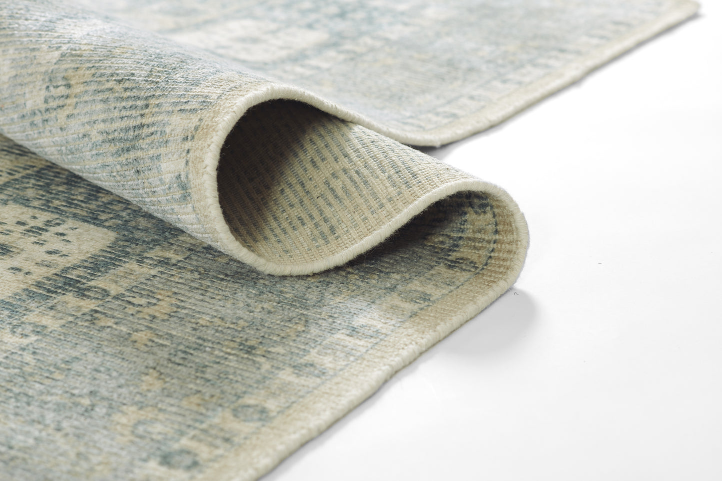 Blue and beige distressed rug with a soft woven texture, rolled edge shown for cozy home decor.
