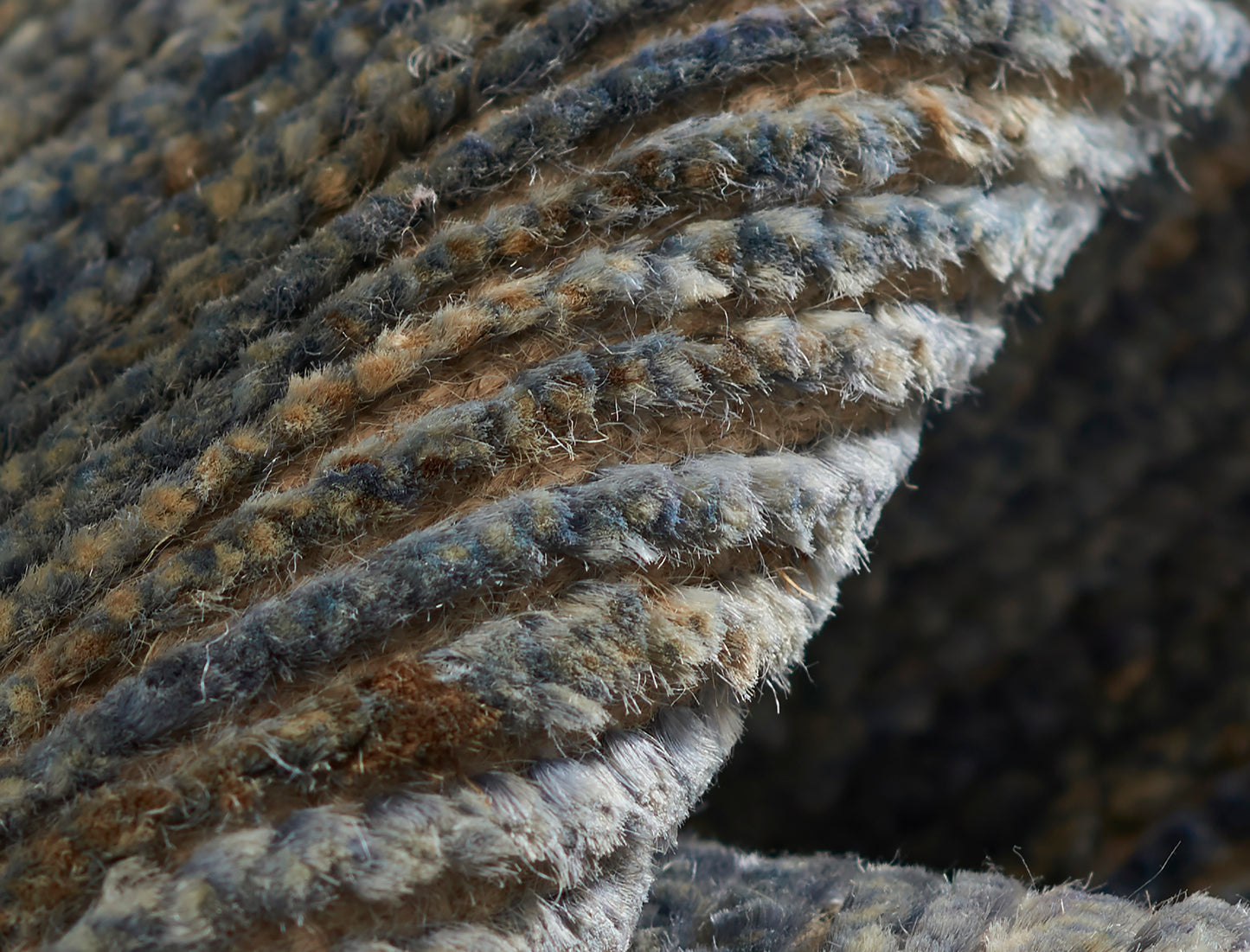 Close-up of a blue-gray braided rug texture with fuzzy fibers, 3'6" x 5'6
