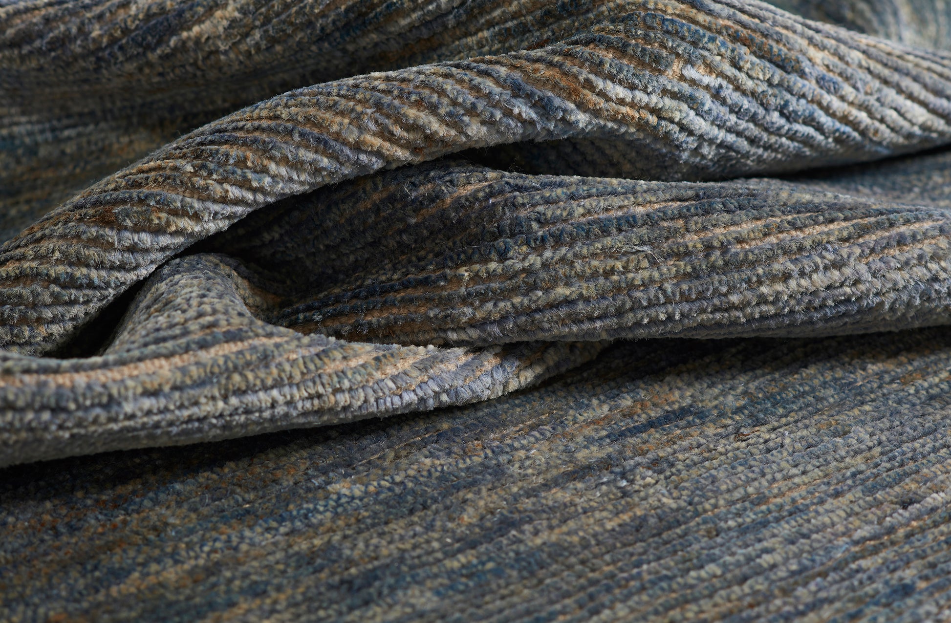 Blue-gray textured boucle rug with thick folds; soft, woven surface; size 3'6" x 5'6