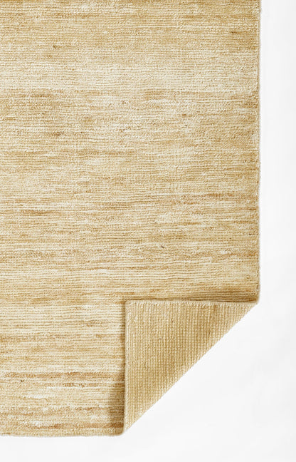 Natural beige jute rug with textured weave and a folded corner detail.