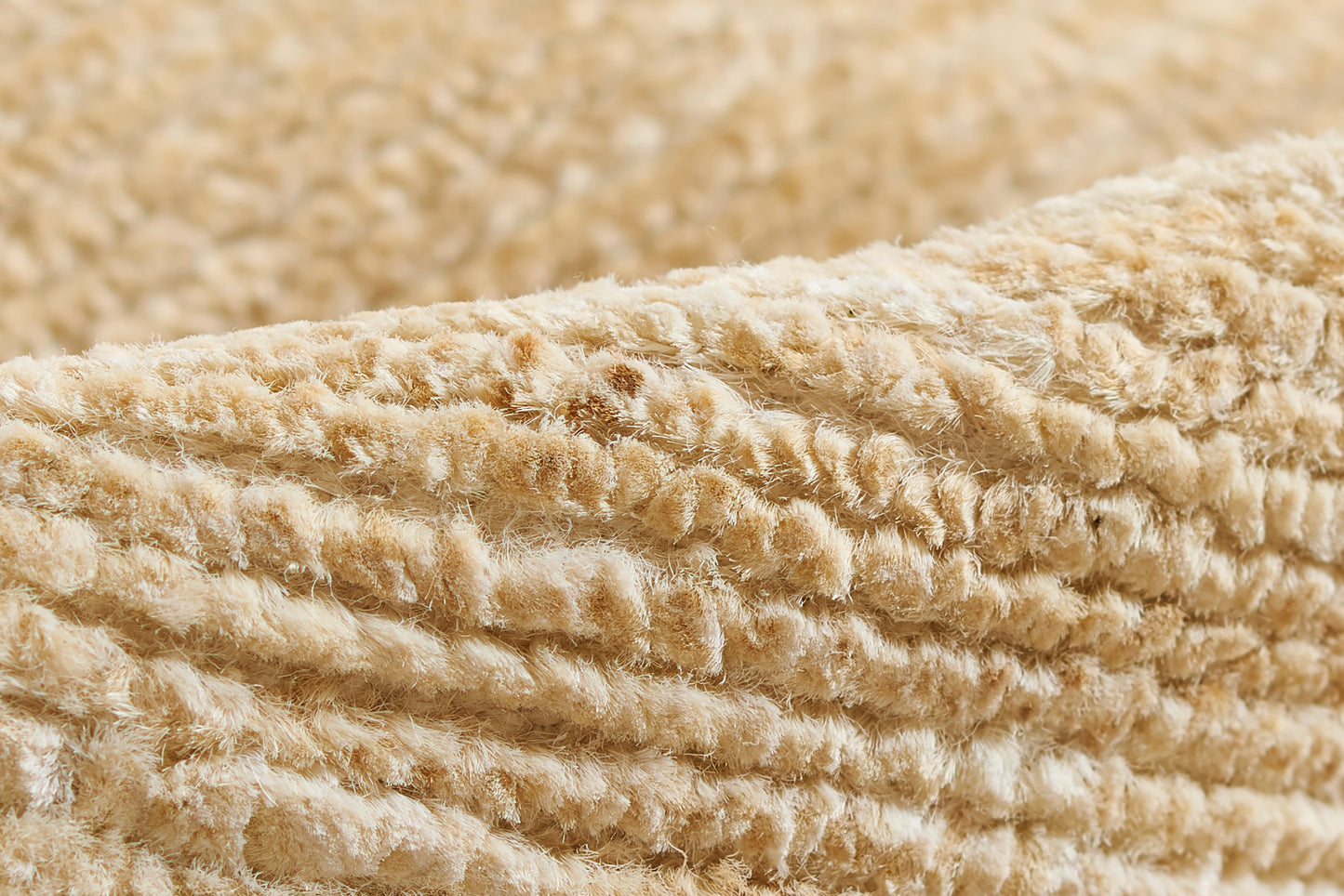 Beige plush fabric with thick looped pile; natural color, soft rug texture for a cozy rug.
