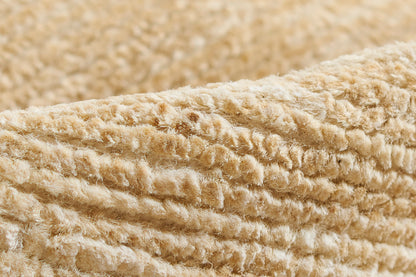 Beige plush fabric with thick looped pile; natural color, soft rug texture for a cozy rug.