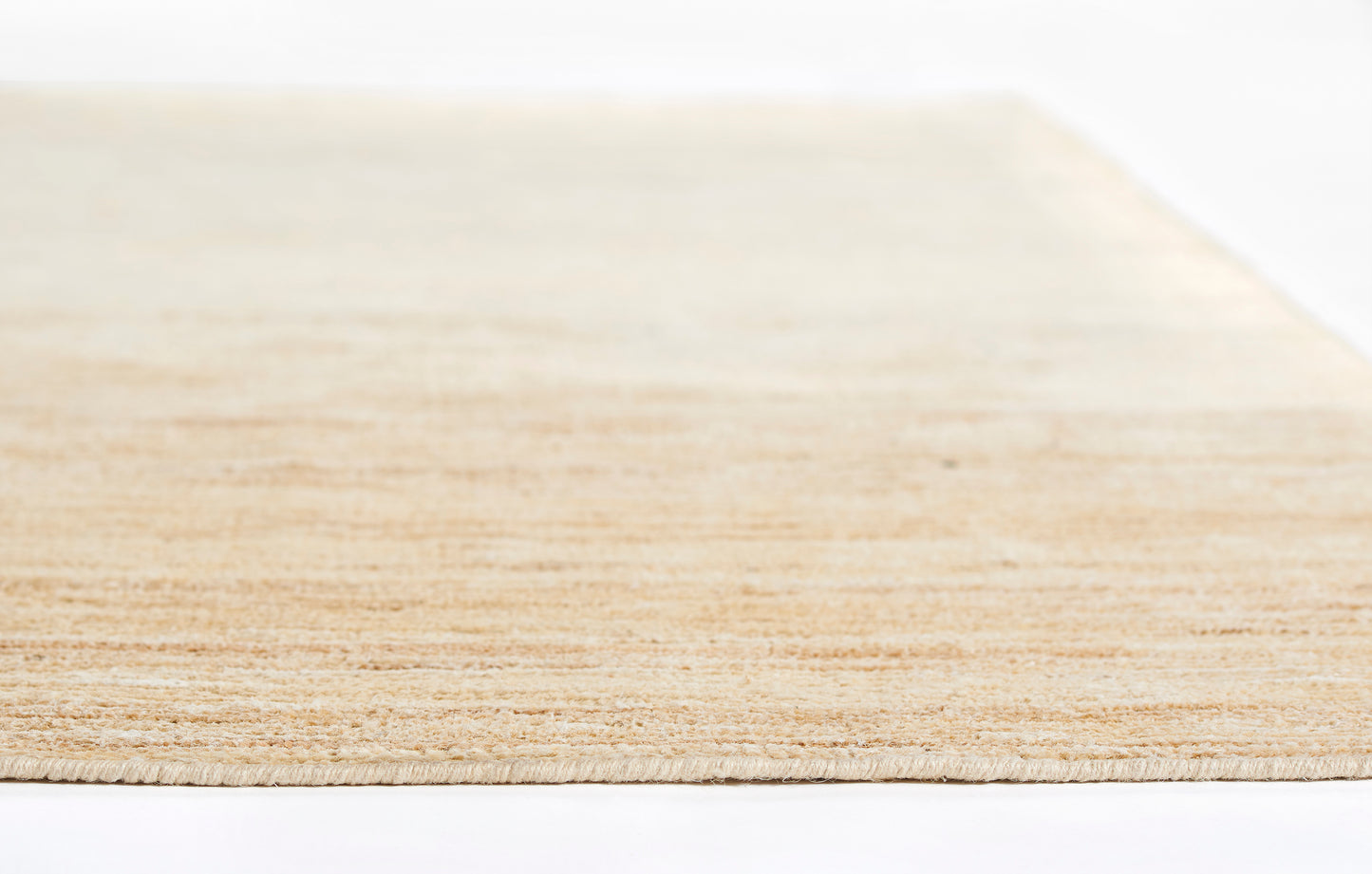 Light natural rug with subtle texture; rectangular 5' x 8' rug.