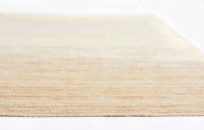 Light natural rug with subtle texture; rectangular 5' x 8' rug.