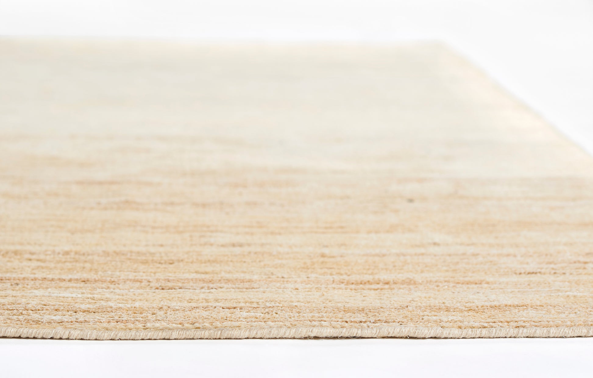 Close-up of a natural beige rug runner with woven texture, measuring 2 ft 3 in by 8 ft.