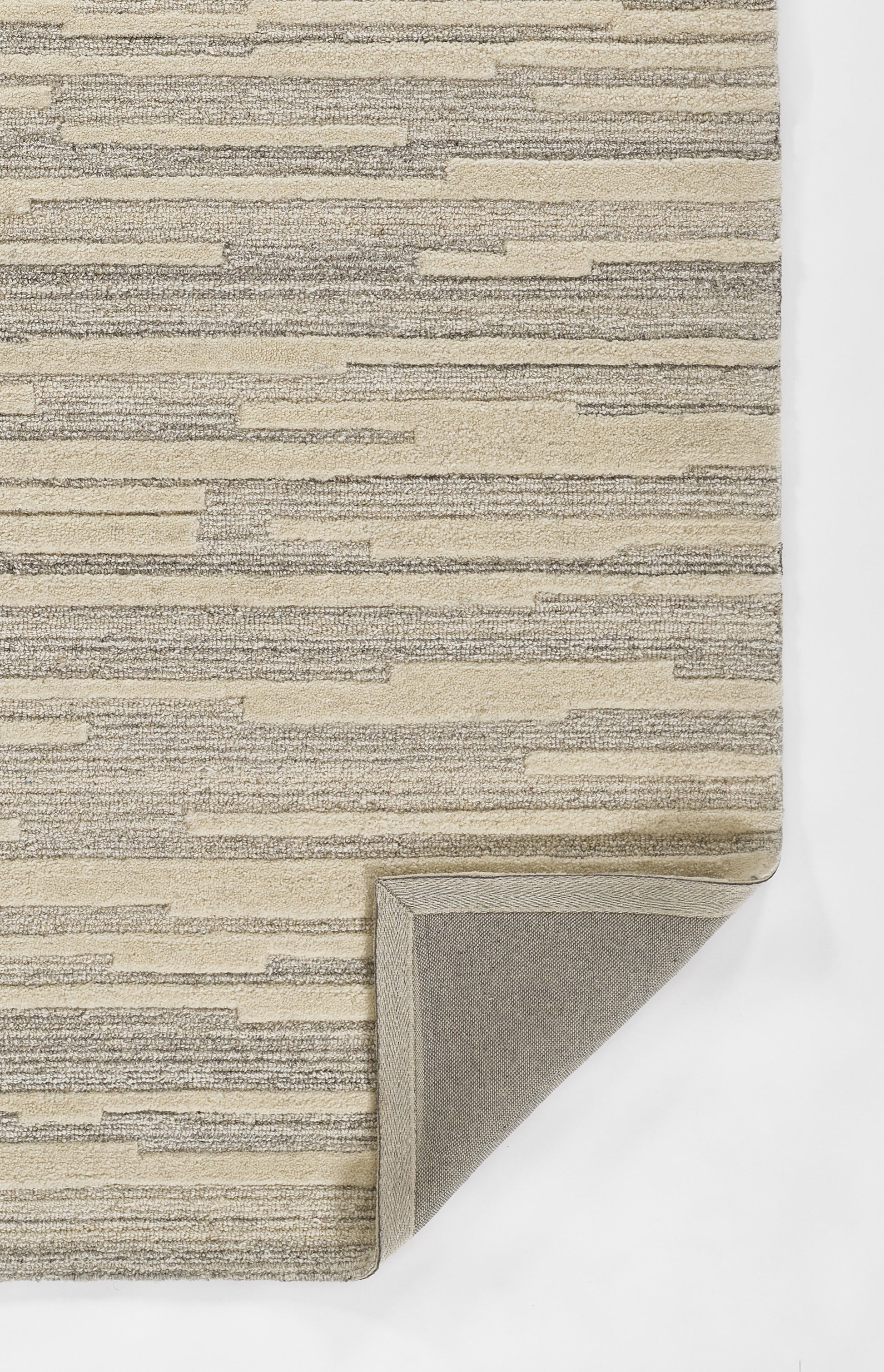 Gray-beige striped area rug with thin horizontal bands; folded corner reveals backing.