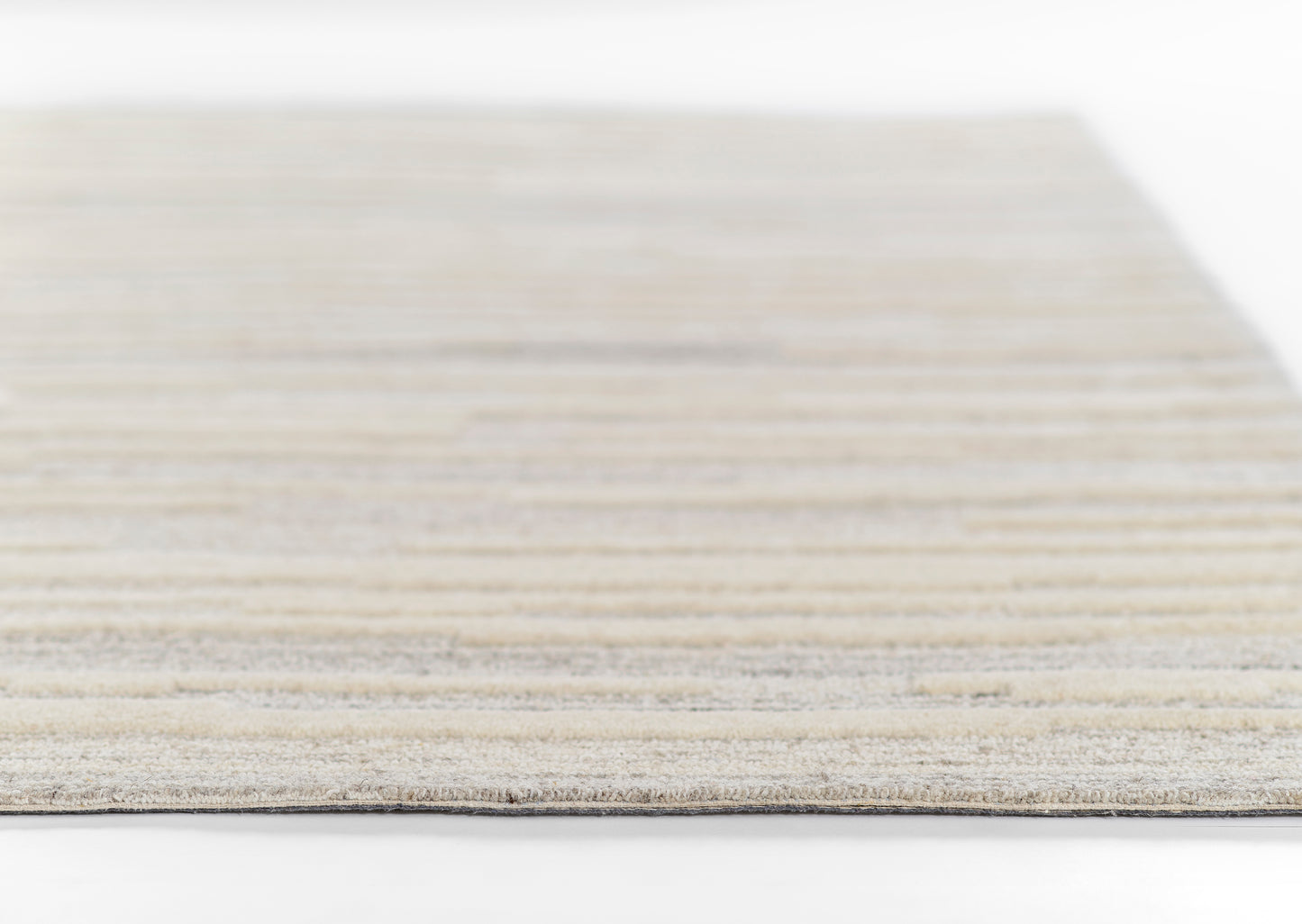 Rectangular woven rug in gray-beige tones with subtle stripes for modern living spaces.