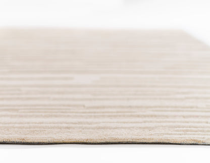 Taupe beige woven rug with subtle horizontal stripes, low-pile natural fiber texture.