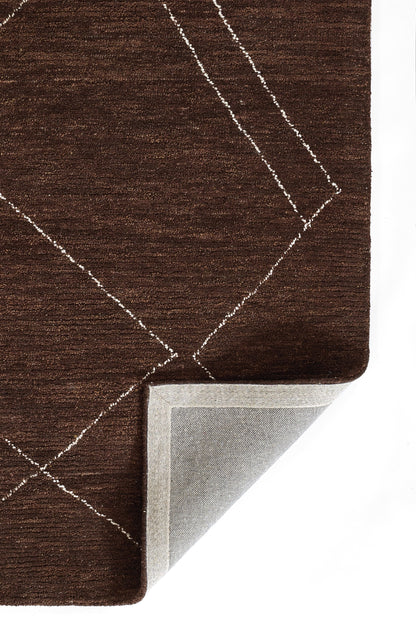 Brown textured rug with white diamond geometric lines; folded corner reveals light gray backing.