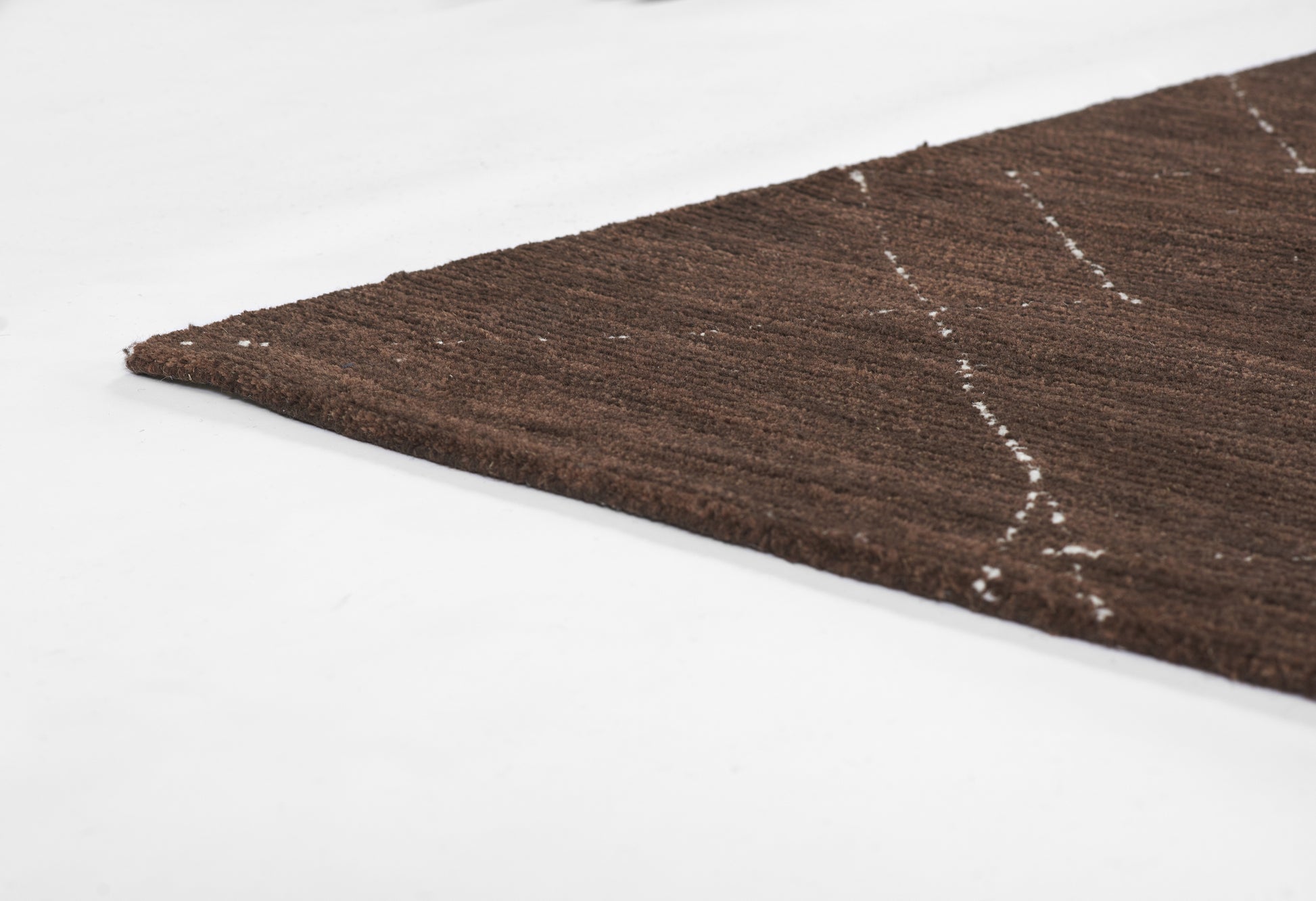 Brown textured runner rug with white geometric lines on white background; size 2'3" x 8'.