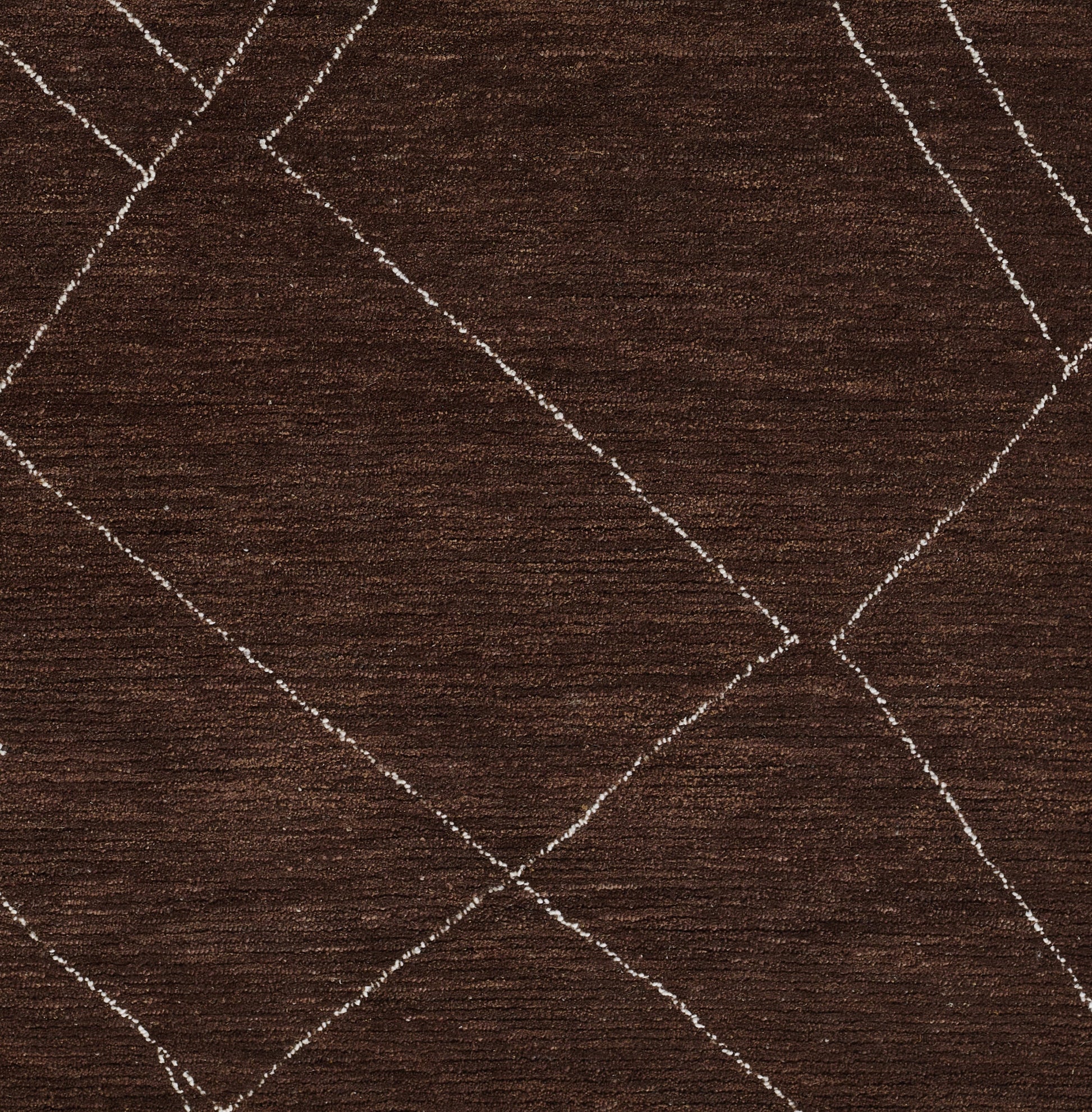 Dark brown rug with cream diamond lattice pattern and soft, textured pile.