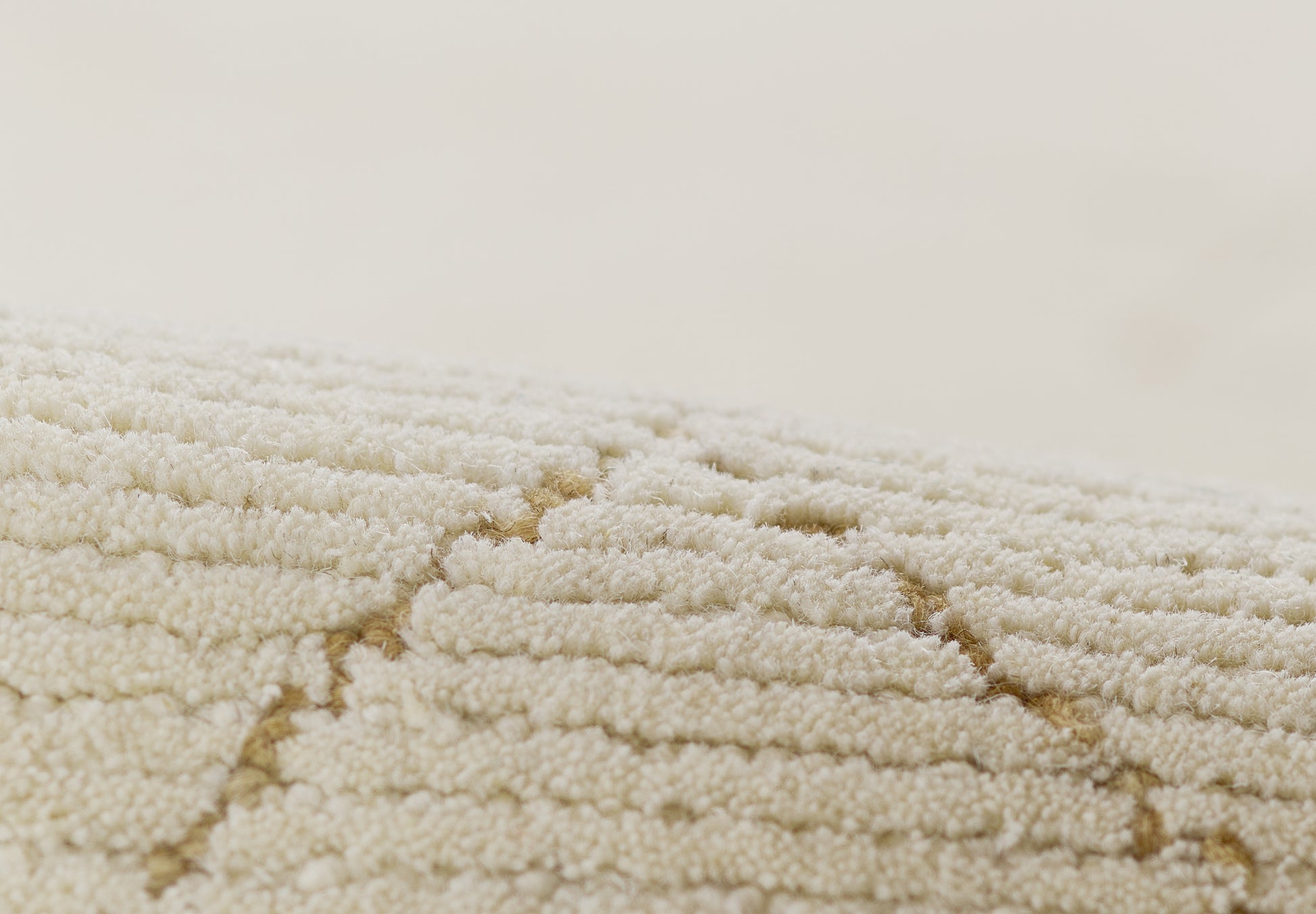 Cream ivory shag rug close-up with textured loop pile & geometric diamond pattern.