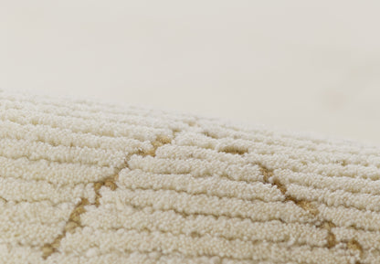 Beige plush rug with cream geometric chevron lines and soft loop pile.