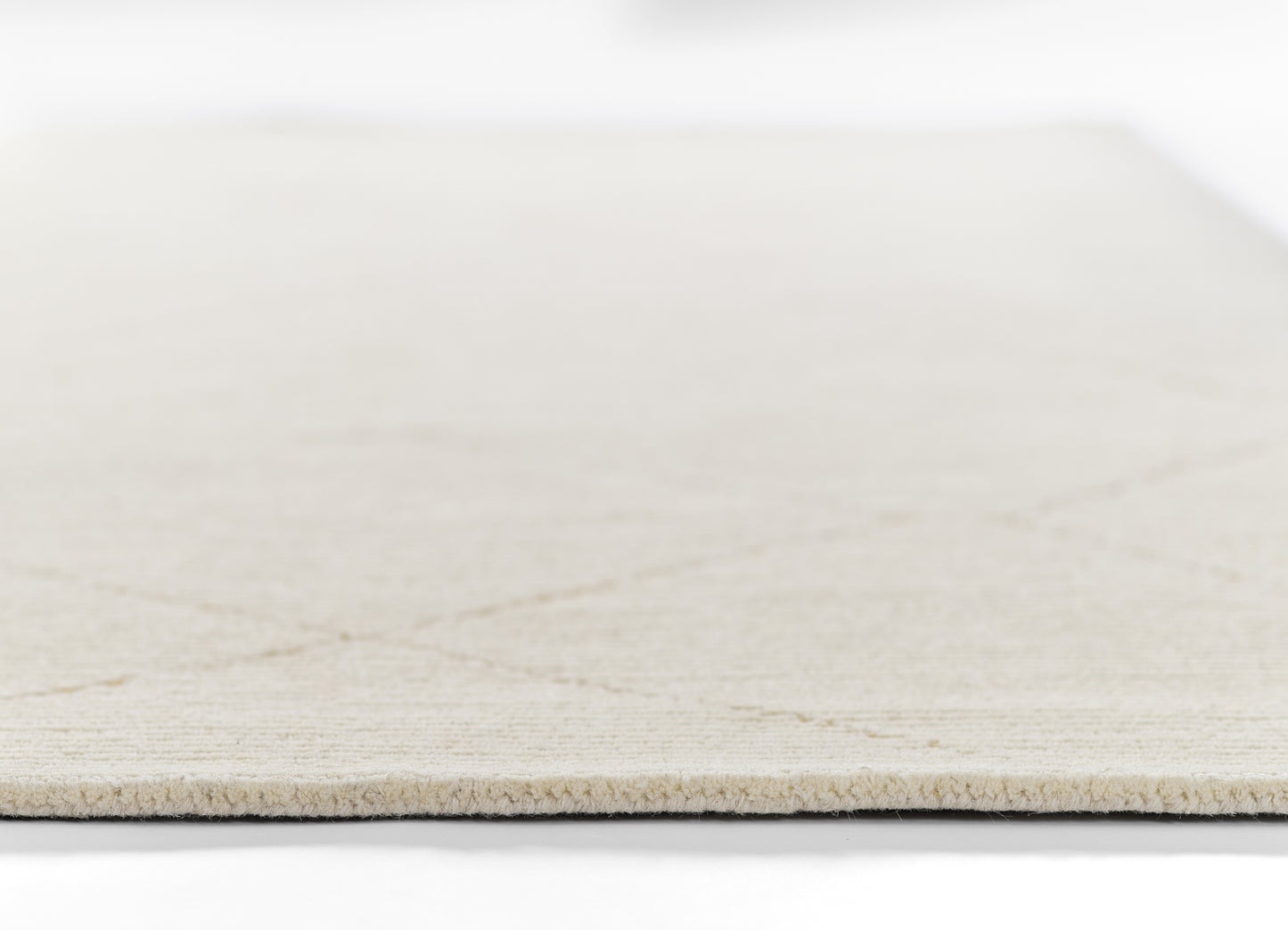 Close-up of a light beige rug with subtle woven texture; 8' x 10' rug.