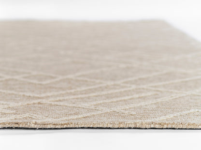 Natural beige woven rug, close-up edge view showing subtle geometric pattern and low pile.