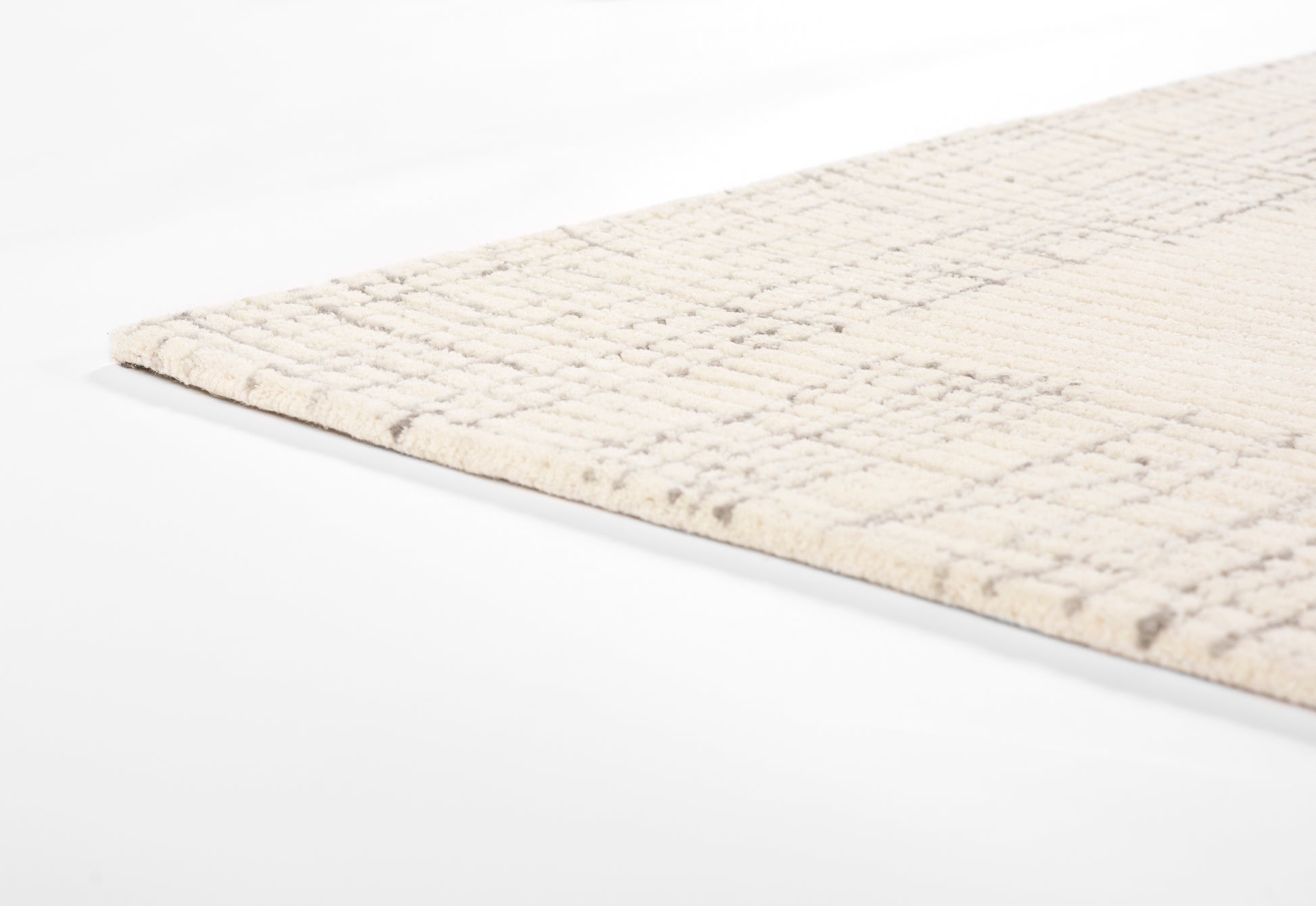 Beige woven area rug with subtle square grid pattern and cropped edge, modern rectangular decor.
