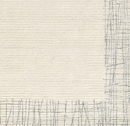Cream textured rug with a gray plaid border along the bottom and right edges.
