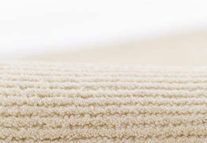 Beige loop-pile carpet close-up, showing soft, textured surface for cozy living room or bedroom decor