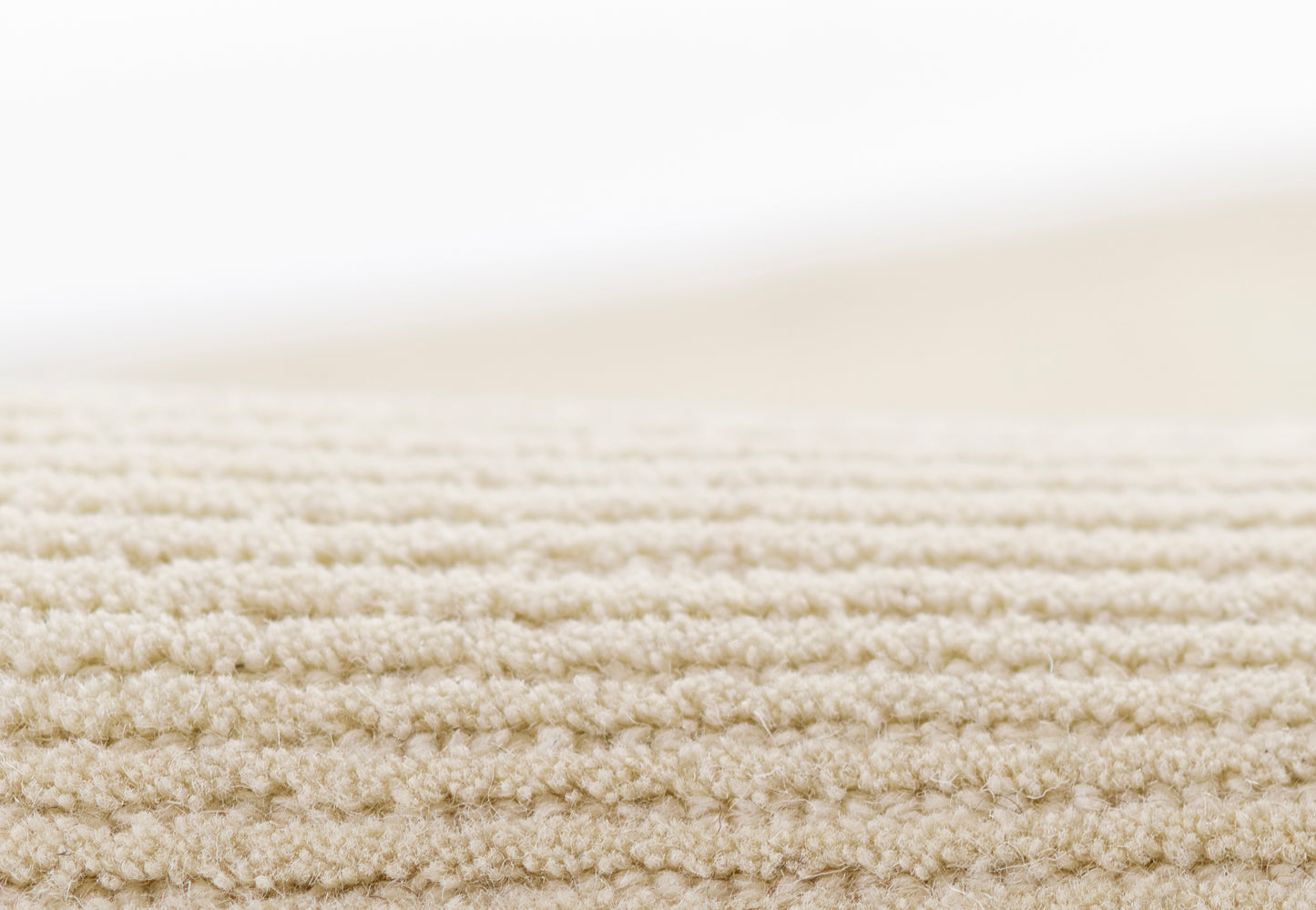 Beige textured loop-pile runner rug, 2'3" x 8'.