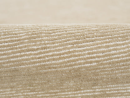 Beige taupe rug close-up showing soft loop pile with subtle cream/white horizontal stripes
