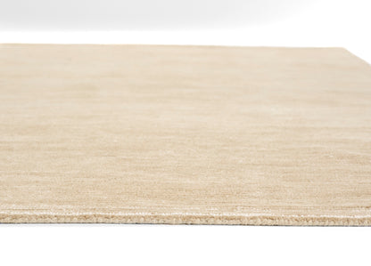 Natural light-tan rug (8' x 10') with subtle texture and finished edge.