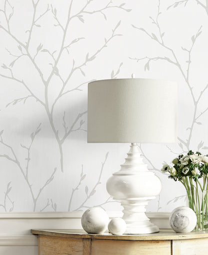 Off-white satin fabric with a botanical branching pattern.