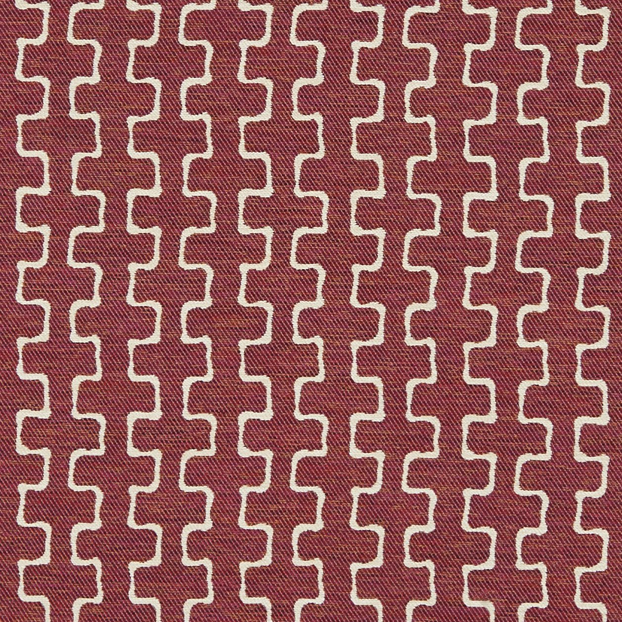 Outdoor jacquard fabric in burgundy/red and orange/rust with a geometric motif; woven texture.