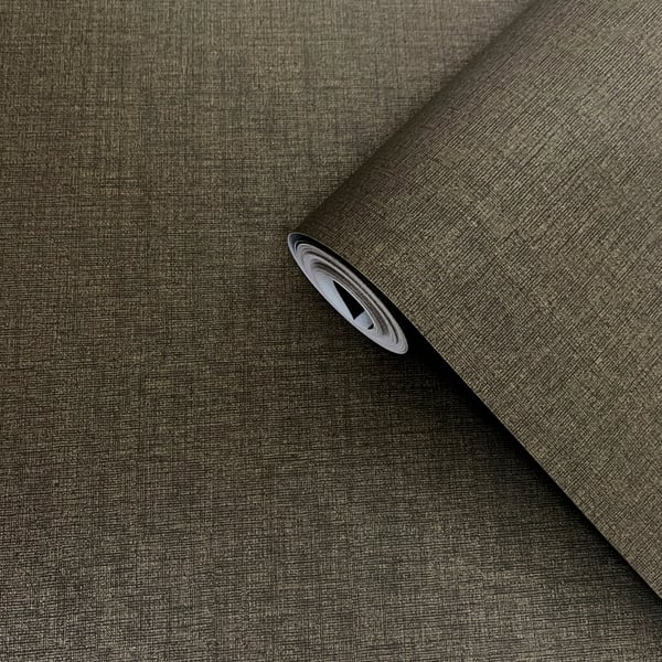Brown plain wallpaper roll with a subtle sheen, partially unrolled on a dark brown surface.